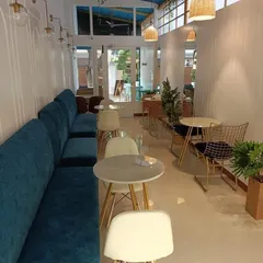 Seating is more than just functional; it's a core part of the customer experience. We selected plush, teal banquette seating to provide comfort and add a strong pop of color against the clean, white paneled walls.
