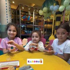 Teamwork makes the dream work! Three friends show off the clay Ganesha idols they made together at our craft table, surrounded by all the tools for a fun, creative session.