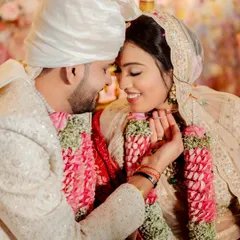 Writing their own fairytale in soft smiles and secret glances. The bride's minimalist makeup in her ivory lehenga is pure elegance.