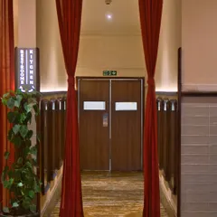 The dramatic entrance to our kitchen, framed by red curtains. This is where the magic begins, a space defined by feeling as much as function.