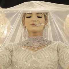 For this bride, we created an ethereal and soft look to complement her elegant white wedding attire. The focus was on luminous skin, subtle contouring, and delicate eye makeup to create a timeless and graceful bridal style.