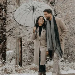 A walk through a winter wonderland in Almaty. This candid couple portrait showcases the cozy romance of a pre-wedding shoot in the snow.