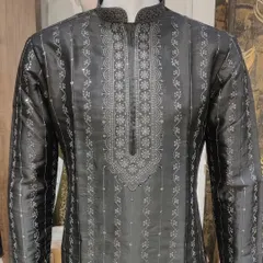 A black silk kurta with vertical stripes and a heavily embroidered neckline. The combination of fabric and detailed threadwork makes this a sophisticated choice for an evening event.