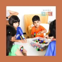 A young boy at a Namma Nook workshop fully engaged in building with colorful cubes. Hands-on, tactile play is fundamental to developing spatial reasoning and problem-solving skills.