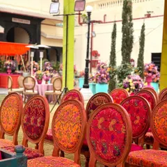 Even the chairs tell a story. For this Mehendi, I sourced chairs with custom upholstery featuring vibrant, traditional patterns to complement the overall decor theme.