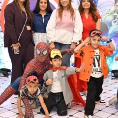 Spider-Man posing with the kids. Having their favorite hero at the party is a dream come true for them.