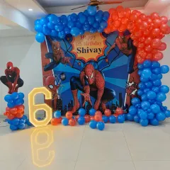 This is a complete Spider-Man theme I created for a 6th birthday. The setup includes a custom backdrop with the birthday boy's name, a large illuminated number '6', character cutouts, and a balloon arch in signature red and blue.