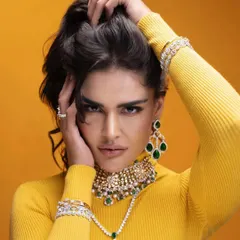 This image combines a bold yellow turtleneck with a stunning emerald and diamond choker. The contrast makes the jewelry pop, showing how I use color theory in my styling to create memorable visuals.