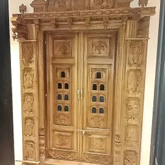 A masterpiece of traditional woodwork, this intricately carved pooja room door is a work of art. It brings a sense of heritage and divinity to the home's entrance.