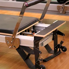 A close-up of the Reformer. This machine challenges your body with every movement, promoting balance, control, and strength. It’s where you breathe, stretch, and transform.