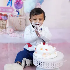 The aftermath of a successful cake smash. This photo captures the pure, uninhibited joy of making a glorious mess.