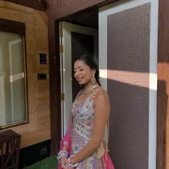 A happy wedding guest enjoying the function. Her simple braided hairstyle is perfect for a long day of celebrations.