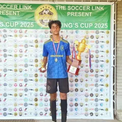 A U15 player proudly poses with the runners-up trophy and his individual award after a successful tournament weekend. His achievement reflects the passion and skill of our youth squads.