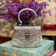 Here is another view of my classic carved silver clutch, this time with a sturdy, elegant handle. It’s a versatile piece that can be carried as a handbag or a clutch.