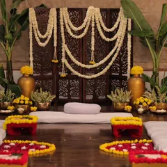 The complete setup for an intimate, at-home mehendi ceremony. We used floor seating, banana leaves, jasmine and marigold flowers, and brass props to create a warm, traditional South Indian vibe.