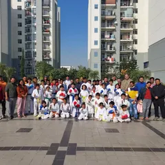 An outdoor belt grading event. We take pride in our students' progress and celebrate their achievements as a community.