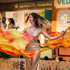 A graceful dancer with vibrant silk fans adds a touch of elegance and movement to the 'Wild One' jungle party. I can source performers that perfectly complement your chosen theme.