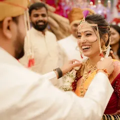 A moment of pure, uninhibited laughter. The bride's face is lit up with joy, and her radiant makeup only enhances her natural glow.