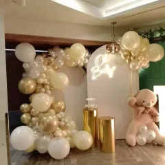 A slightly different view of the 'Oh Baby' setup, showing the fullness of the balloon garland and how it frames the central arched backdrop. The soft colors create a warm and welcoming atmosphere for the celebration.