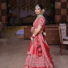 A side profile of the bride, showing how the makeup and hairstyle come together. The neat bun is adorned with flowers, and the HD makeup looks seamless from every angle.