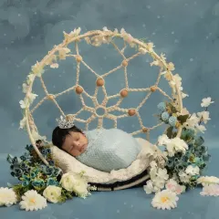 A slightly different angle of this dreamy setup, showing the beautiful details of the dreamcatcher prop and the baby wearing a tiny crown.