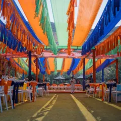 The vibrant ceiling decor for the Mexican Mehendi, with colorful fabric draping and tassels creating a festive canopy over the event space.