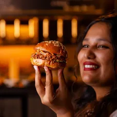 Outdoorsy Texan summer weekends inspired this Hickory-Smoked Pulled Pork Burger. Tender pork is slowly smoked, rubbed with a tangy barbecue sauce, and served in a toasted Japanese bun. It's the closest Bangalore can get to Kansas.