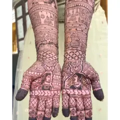 A beautiful example of Raja-Rani (King and Queen) style portraits for a bride. The design is filled with traditional elements like elephants and hanging jhumkas.