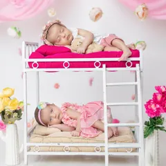 Double the giggles, double the love! This creative bunk bed prop is so much fun for twin photoshoots, telling a story of their shared childhood.