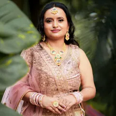 A close-up portrait of the bride, focusing on her beautiful jewelry and gentle smile.