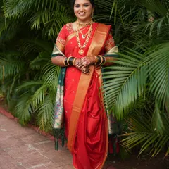 This bride looks stunning in her red Nauvari saree. The airbrush makeup ensures a flawless finish that lasts through all the wedding rituals.