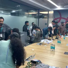 A corporate training session is highly interactive. Here, participants are engaging in a hands-on activity to understand how accessories and clothing details can effectively manage one's image in professional and social scenarios.