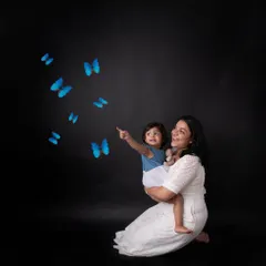 There's nothing more special than the bond between a mother and her child. I always encourage parents to jump into the photos. In this mommy-and-me portrait, we added a touch of magic with these blue butterflies to create a dreamy, unforgettable image.