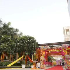 This wide shot shows the full scale of a festive Mehendi entrance. I combined colorful drapes with intricate umbrella installations and marigold strings to create a grand and welcoming passage for guests.