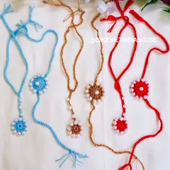 These handmade crochet Rakhi and Lumba sets are available in a variety of colors like sky blue, golden brown, and bright red, each adorned with delicate pearls.