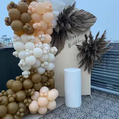 For a modern and chic birthday celebration, we can create stunning decor like this. The arrangement features a sophisticated balloon arch in neutral tones with pampas grass accents, providing a perfect photo backdrop for your event.