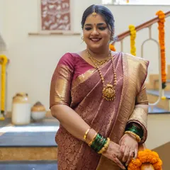 The bride, looking radiant in her family home in Goa, surrounded by traditional marigold decorations.