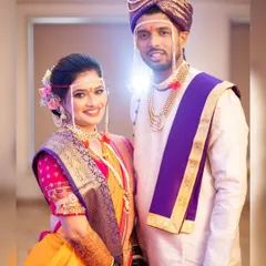 A picture-perfect moment for this adorable Marathi couple. The bride, Trupti, is radiant in her yellow Nauvari saree, with traditional makeup and a floral-adorned bun.