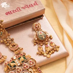 A closer look at the earrings accompanying our Maharani Haar. They perfectly mirror the central pendant's Bikaneri enamel work and gemstone setting, designed to complete the look of regal sophistication.