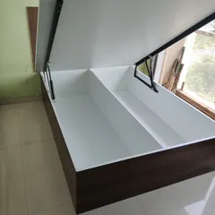 I design beds with hydraulic lift-up mechanisms that reveal a large, open storage space underneath. This is perfect for storing luggage, extra bedding, and other bulky items out of sight.
