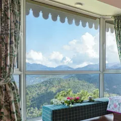 For us, the greatest luxury is a connection to nature. In this Kasauli mountain home, we designed the master bedroom's bay window not just as a feature, but as a destination for quiet contemplation, offering uninterrupted views of the Himalayan valley.