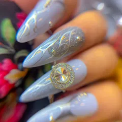 A detailed macro shot of the Navratri nail art, focusing on the texture of the glitter nail and the intricate silver line work.