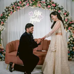 The moment it becomes official. Sarthak gets down on one knee to propose to Swati during their engagement ceremony, under a neon sign that says it all: "Better Together."