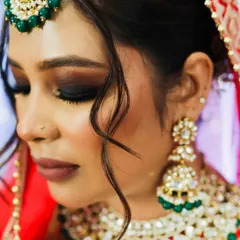 A detailed close-up of the eye makeup. You can see the careful blending of dark eyeshadows and the sharp winged liner that defines the eye shape. This kind of dramatic eye makeup is a favorite for brides who want a bold and unforgettable look.
