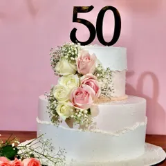 Celebrating 50 golden years with this elegant two-tiered floral cake. Adorned with fresh roses, it’s a timeless design for a truly special milestone anniversary.