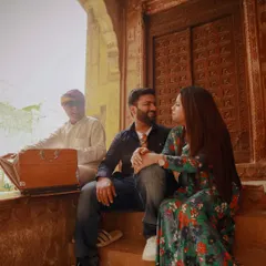 A candid moment during a pre-wedding shoot in Rajasthan, with a local musician adding an authentic cultural touch.