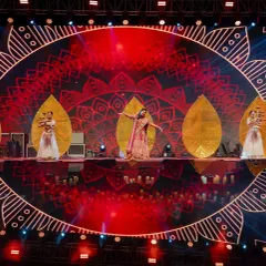 The stage design for our 'Chandni Ratein' theme featured a stunning mandala graphic on the LED screen. The bride's performance, with dancers holding leaf-shaped props, created a beautiful, layered visual.