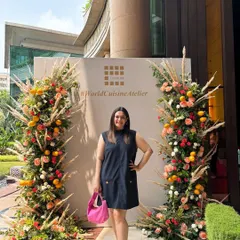 Posing at the beautiful floral entrance of The Qube's relaunch at The Leela Palace. I manage events at luxury hotels, ensuring the experience is five-star from the moment guests arrive.