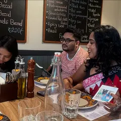 Sharing stories and signing notes at our final group meal. The bonds formed during our intense five-week workshop often lead to lasting friendships and collaborations.