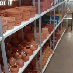 A glimpse of our terracotta section, featuring a variety of pots from standard shapes to whimsical animal designs and orchid pots with ventilation holes.
